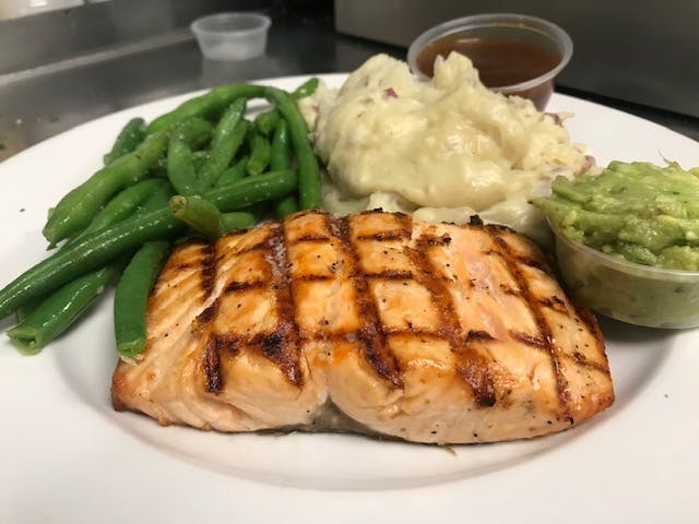 a white plate topped with chicken and vegetables